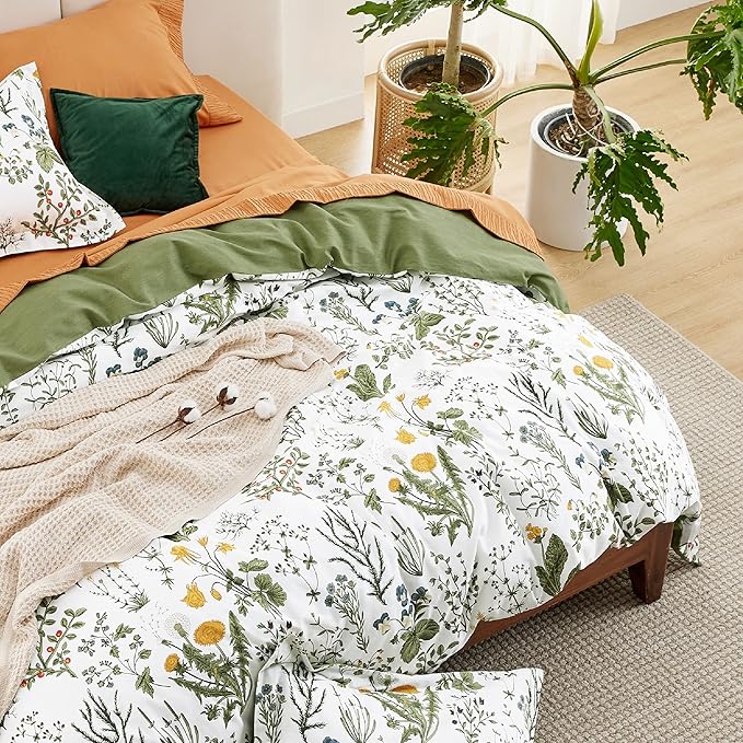 Bed with floral bedding and green pillows in a cozy bedroom setting.
