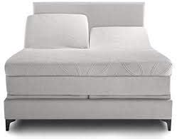 Gray upholstered bed with geometric pattern on a white background