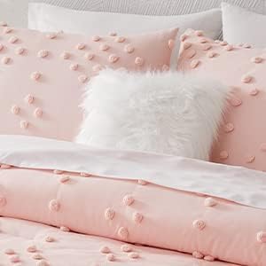 Pink textured bedding set with white fluffy pillow on a light pink background