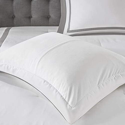 White comforter on a bed with gray headboard