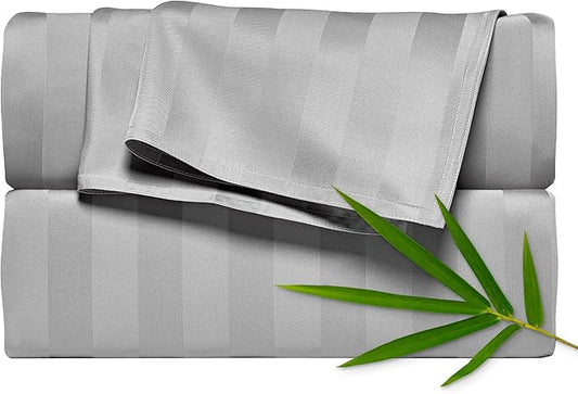 Gray striped fabric with a green leaf on a white background