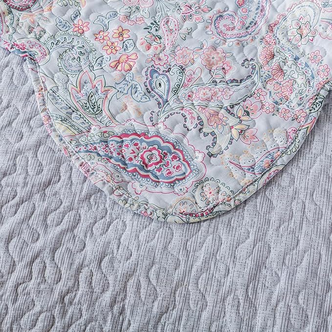 Floral paisley patterned fabric on a textured surface