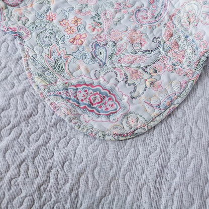 Floral paisley patterned fabric on a textured surface