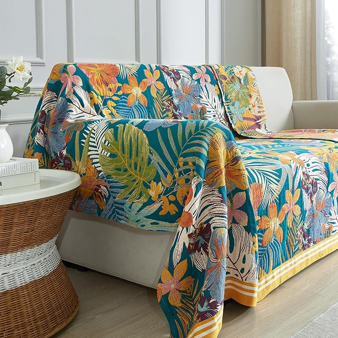 Colorful floral-patterned sofa cover on a white sofa in a living room.