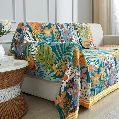 Colorful floral-patterned sofa cover on a white sofa in a living room.