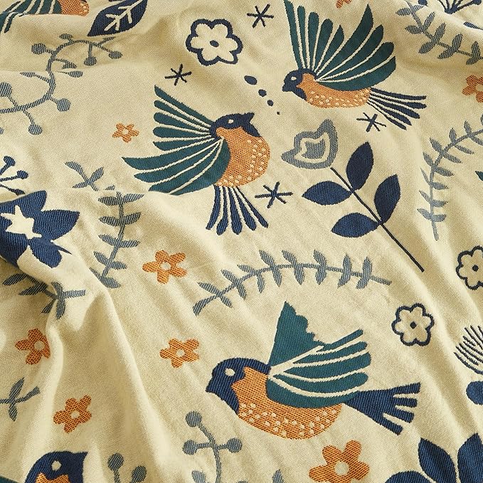 Fabric with embroidered birds and floral patterns on a beige background
