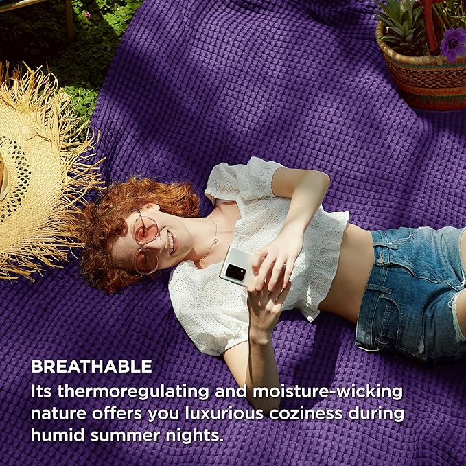 Person lying on a purple blanket outdoors with text about breathable fabric