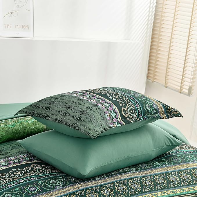 Teal patterned pillows on a bed with a neutral background