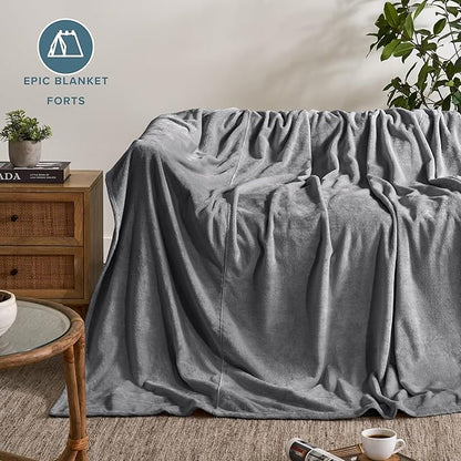 Gray blanket draped over a sofa in a living room setting with 'Epic Blanket Forts' branding.