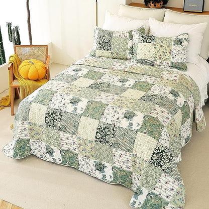 Patchwork quilt with floral patterns on a bed in a bedroom setting.