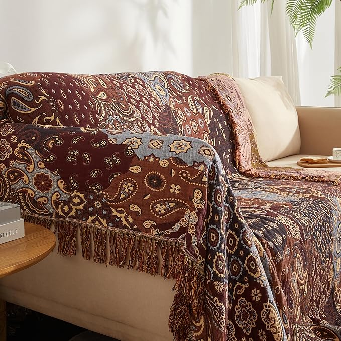 Patterned blanket draped over a bed in a bedroom setting
