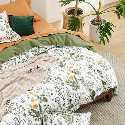 Bed with floral bedding and green pillows in a cozy bedroom setting.